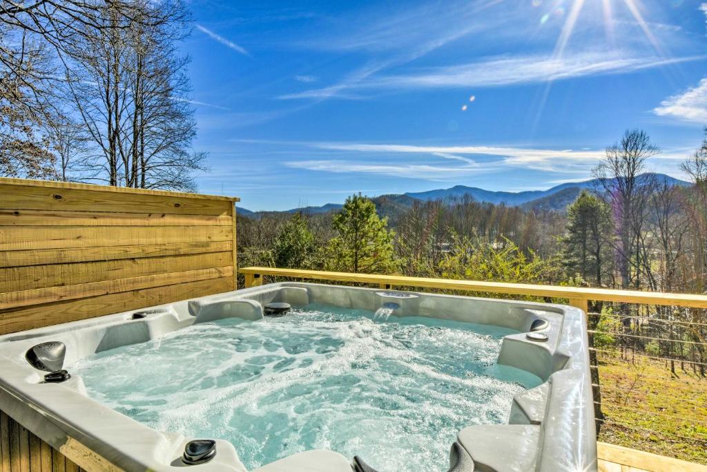 a hot tub on a deck with a view of the mountains at Franklin Home with Hot Tub and Mtn Views! in Franklin