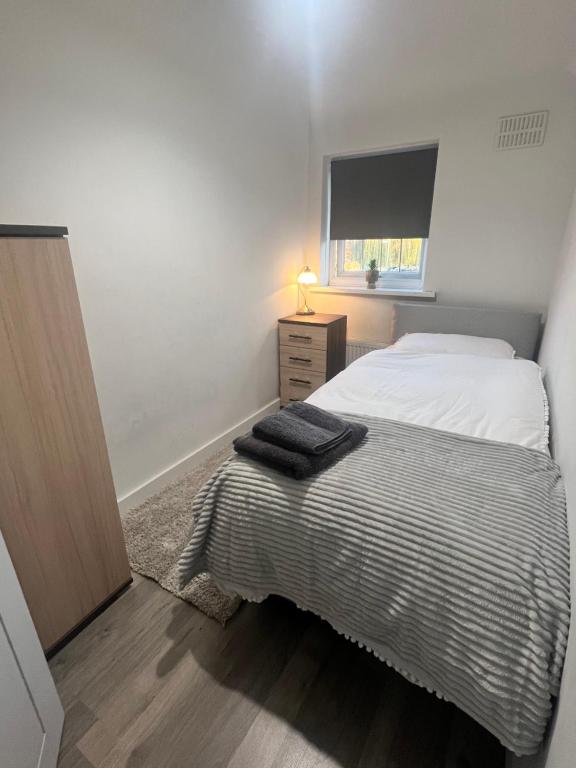 um pequeno quarto com uma cama e uma janela em Lovely Single Room em Hither Green