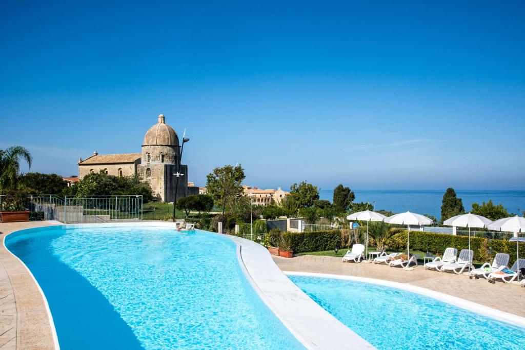 a swimming pool with a view of the ocean at Sentido Michelizia Tropea Resort in Tropea