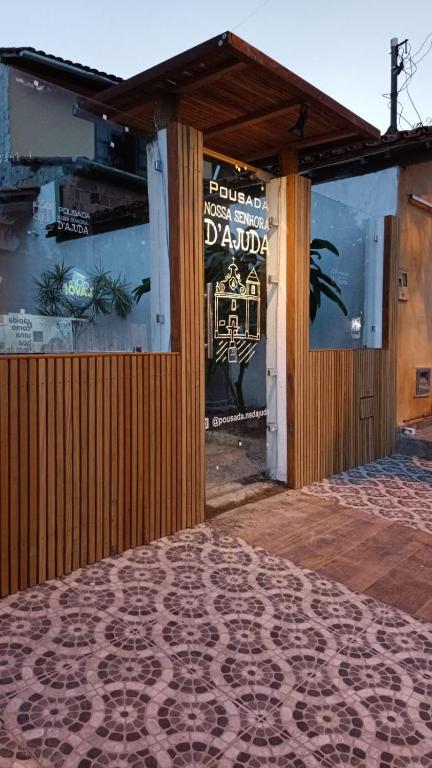 a front door of a building with a sign on it at Pousada Nossa Senhora D'Ajuda in Arraial d'Ajuda