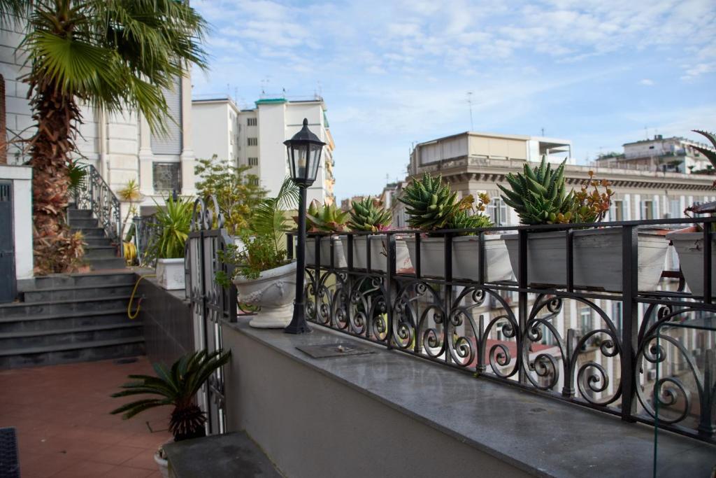 a balcony with a black railing with potted plants at Villa Margherita in Naples