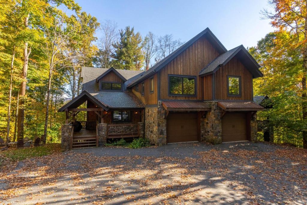 a house in the woods with a driveway at Rustic Cedar Rock Townhome at Eagles Nest in Banner Elk