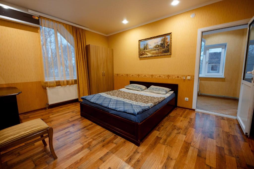 a bedroom with a bed and a wooden floor at Villa Turistica Oasis in Cahul