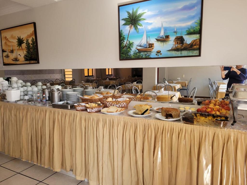 a buffet of food on a table in a restaurant at Inter Hotel in Vitória