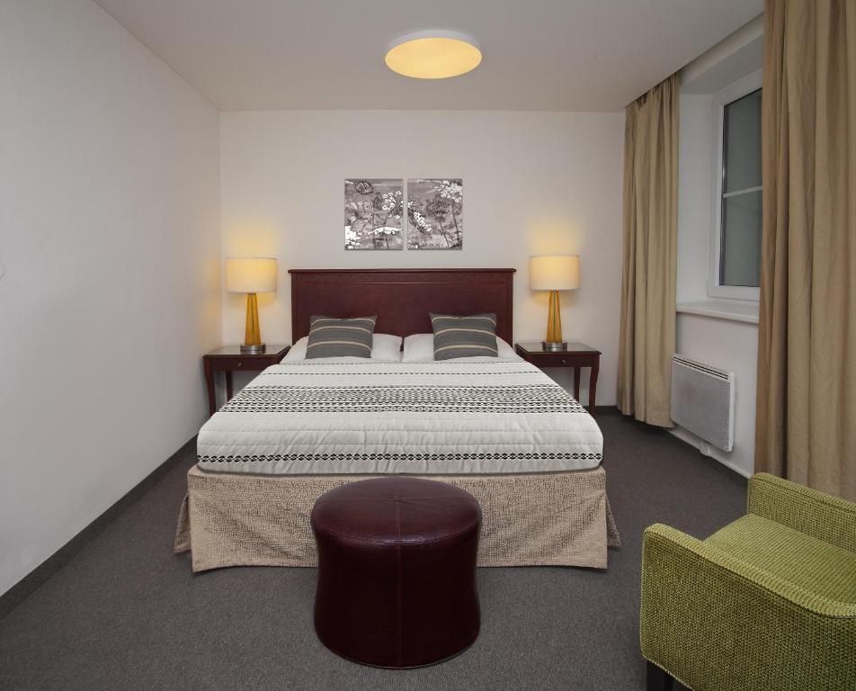 Postel nebo postele na pokoji v ubytování Hotel Petrovy kameny