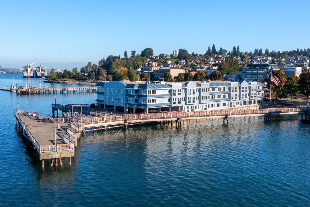 a building on a dock in the water at Silver Cloud Hotel Tacoma Waterfront in Tacoma