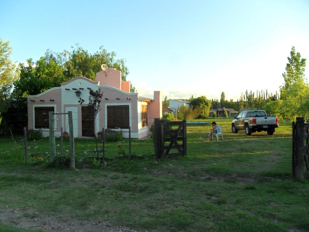 una pequeña casa en un campo con un camión en Casa Câmeron del Mar en San Rafael