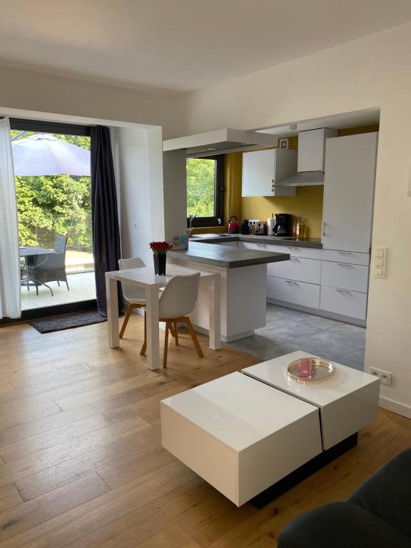 a kitchen and living room with a table and chairs at Appartement met groot terras in Mortsel