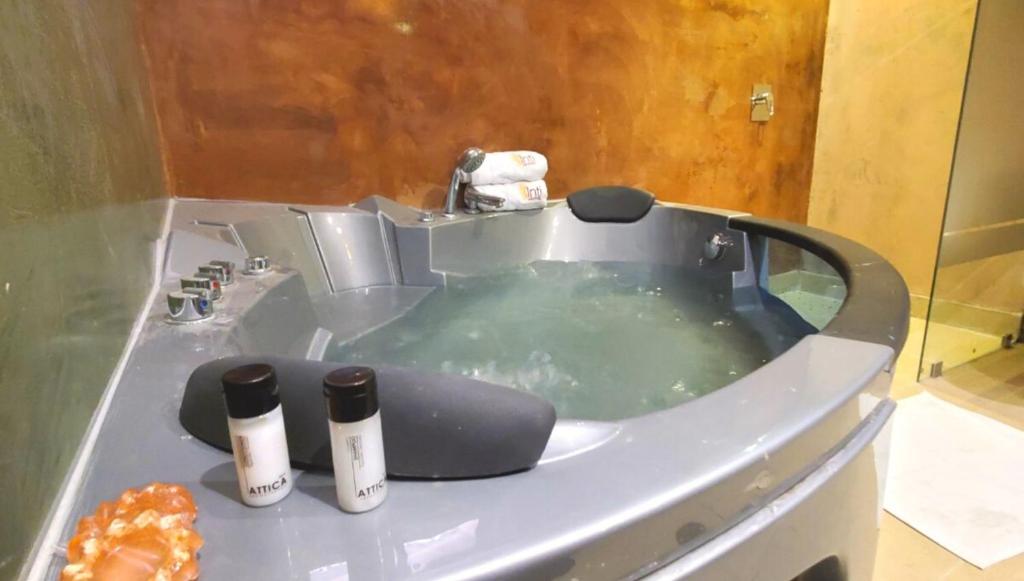 a bath tub filled with water with two bottles on it at Hotel Inti Quito in Quito