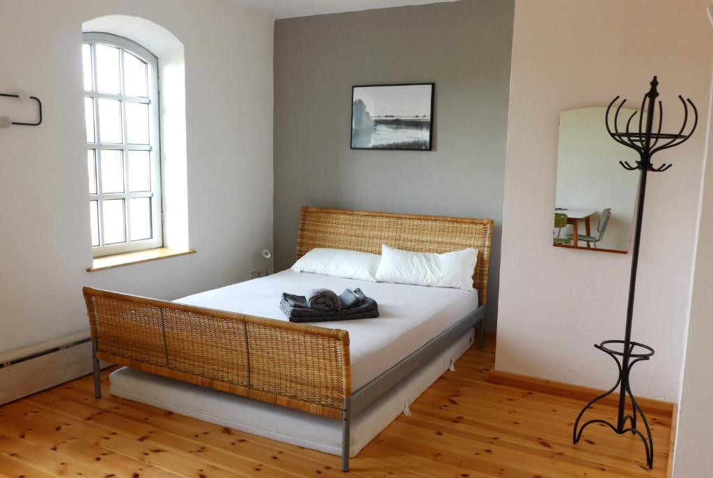 a bedroom with a bed with white sheets and a window at Einfachlosmachen Turmzimmer 