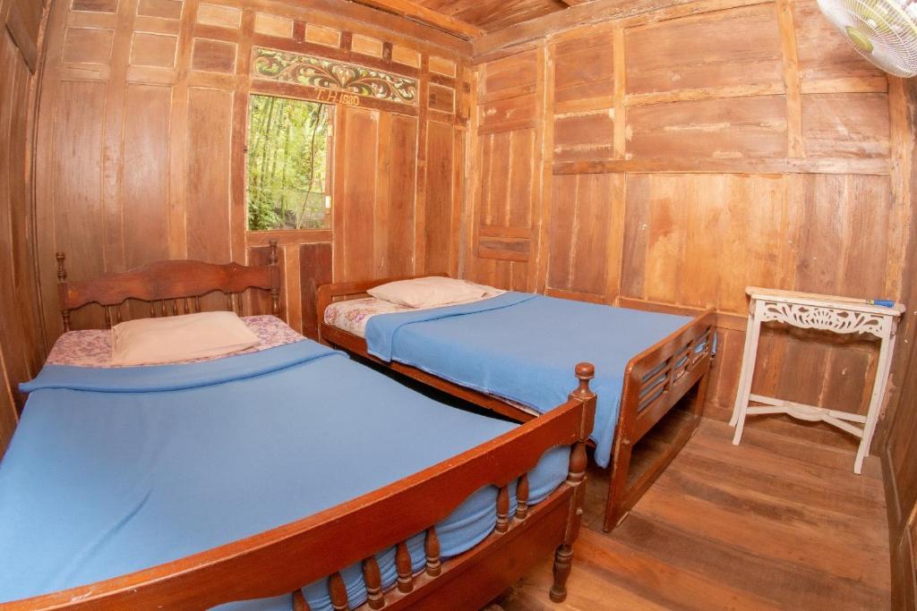 Postel nebo postele na pokoji v ubytování Villa Kampung Ayem Riverside