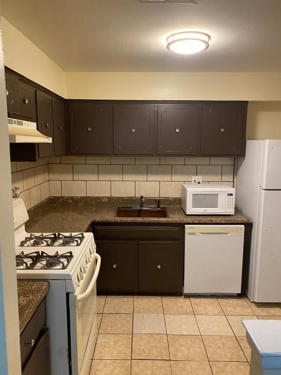 a kitchen with a stove and a microwave at Island Avenue in Philadelphia
