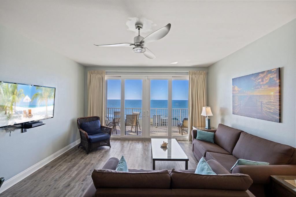 a living room with a couch and a view of the ocean at Laketown Wharf! Sleeps 9 - Resort Beach Condo, Stunning Ocean Views! by Dolce Vita Getaways PCB in Panama City Beach