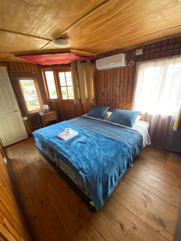 a bedroom in a boat with a bed in it at Hostería Futaleufu in Futaleufú