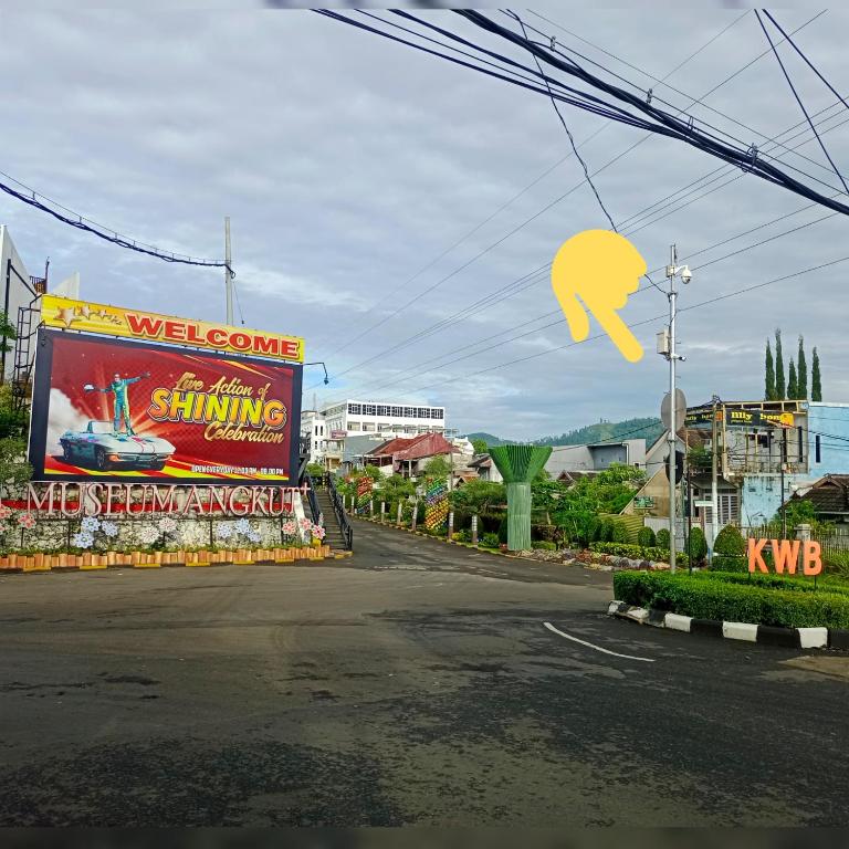 a street with signs on the side of the road at Villa Lilly in Batu