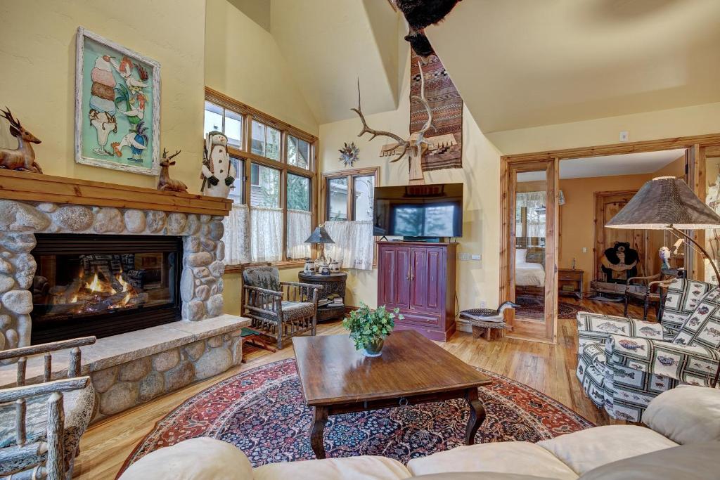 a living room with a stone fireplace at The Perfect Large Family Retreat condo in Beaver Creek