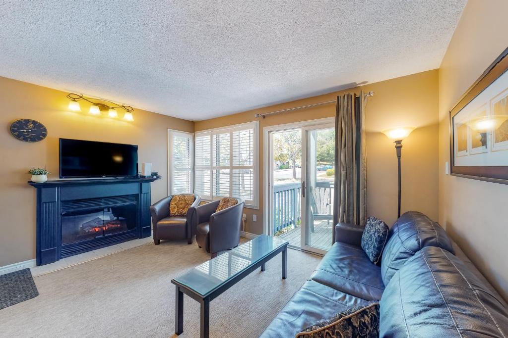 a living room with a couch and a fireplace at Condo 505 at North Creek Resort in Blue Mountains