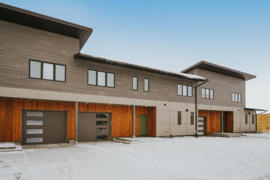 a large building with two garage doors in the snow at The Circle Unit B in Bozeman