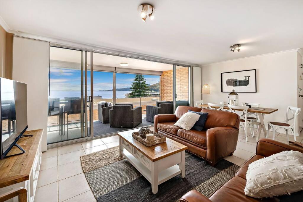 a living room with a couch and a table at The Crest in Shoal Bay