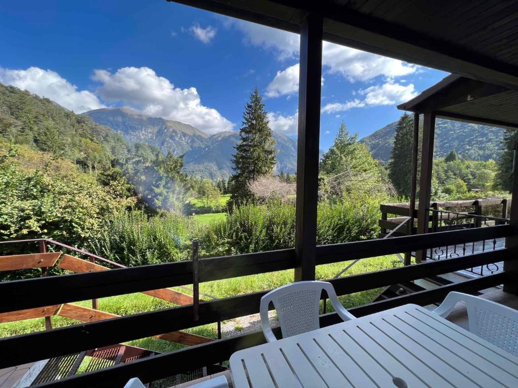 a table and chairs on a balcony with a view of mountains at Apartment in Ledro - Ledrosee 43436 in Ledro