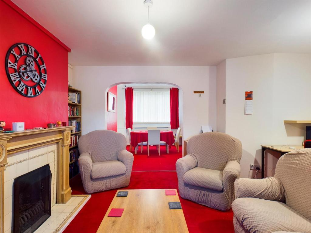 a living room with two chairs and a fireplace at 2BD City Centre Flat nr Anfield Stadium Liverpool in Liverpool