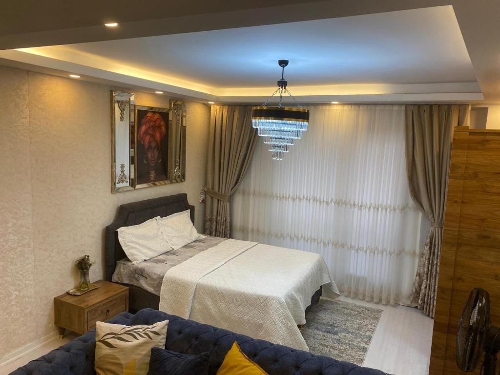 1 dormitorio con 1 cama y 1 sofá en L'élégance de JJM, en Esenyurt