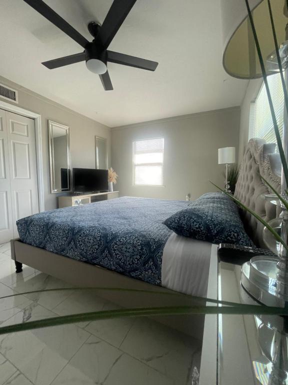 a bedroom with a bed with a ceiling fan at 3 miles to Siesta Key #1 Beach in America in Sarasota