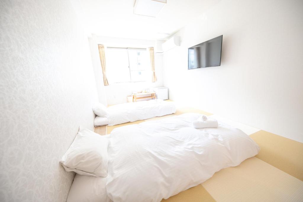 Postel nebo postele na pokoji v ubytování Dotonbori Shinsaibashi Hotel