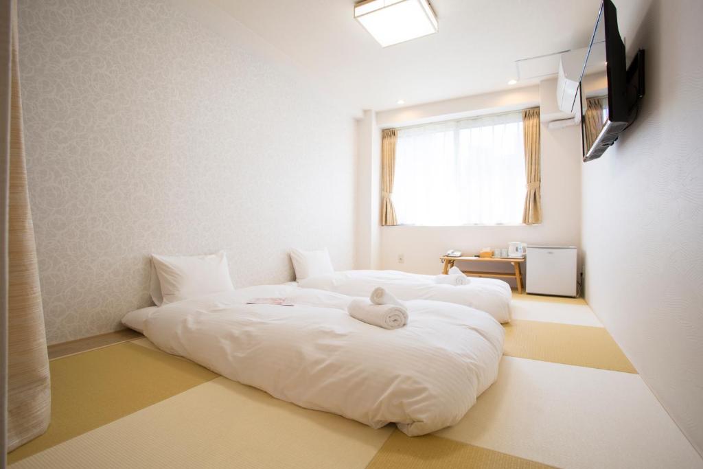 Postel nebo postele na pokoji v ubytování Dotonbori Shinsaibashi Hotel