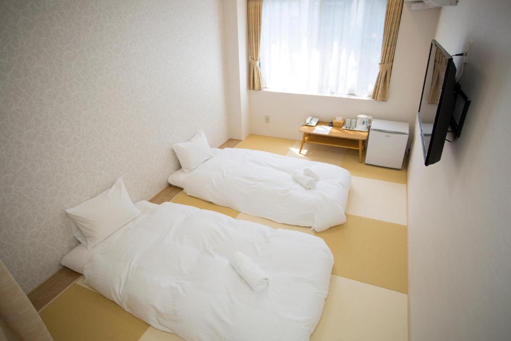 Postel nebo postele na pokoji v ubytování Dotonbori Shinsaibashi Hotel