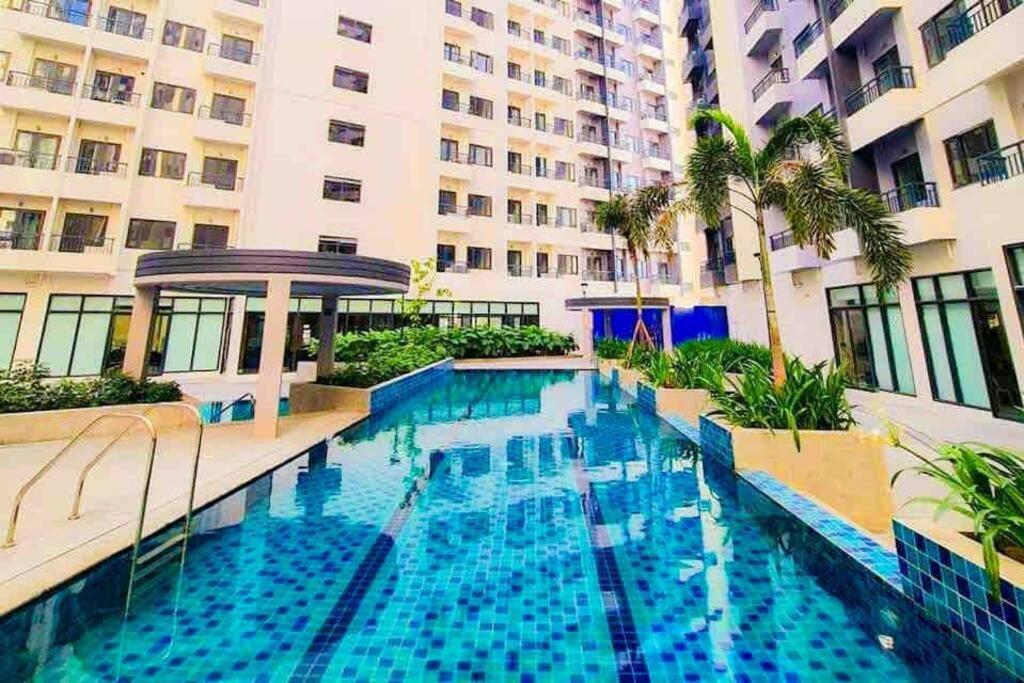 a swimming pool in the middle of a building at Fully furnished 1-BR Condo Unit at Spring Residences in Manila
