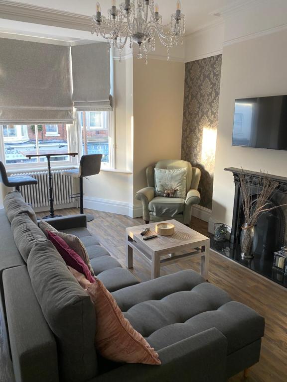 a living room with a couch and a table at The Fort Lytham St Annes in Lytham St Annes