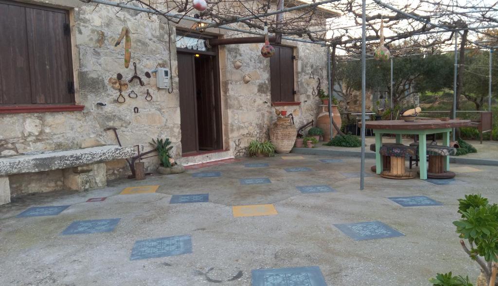 a patio with a table and a building at TRADITIONAL HOUSE MARIA in Azoyirás