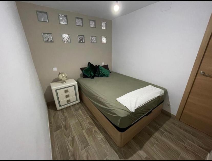a small bedroom with a bed and a side table at La Joya in Navalacruz