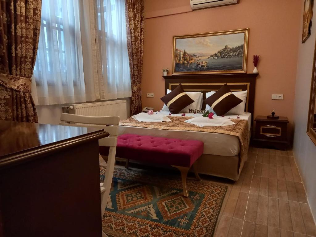 a hotel room with a bed with a red bench at Emirhan Hotel & Sultanahmet in Istanbul