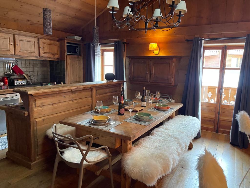 a kitchen with a wooden table with two chairs at l’escalade 3 in Courchevel