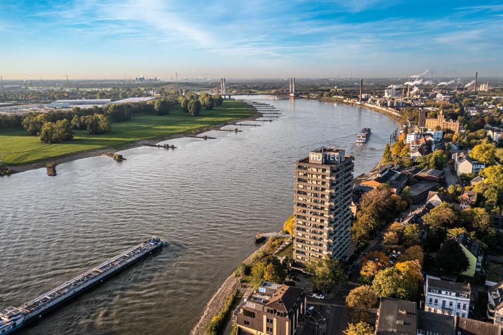 Luftblick auf einen Fluss in einer Stadt in der Unterkunft Hotel Rheingarten in Duisburg