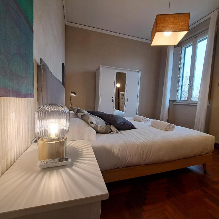 a bedroom with two beds and a lamp on a table at Apartment Corsica 11 in Florence