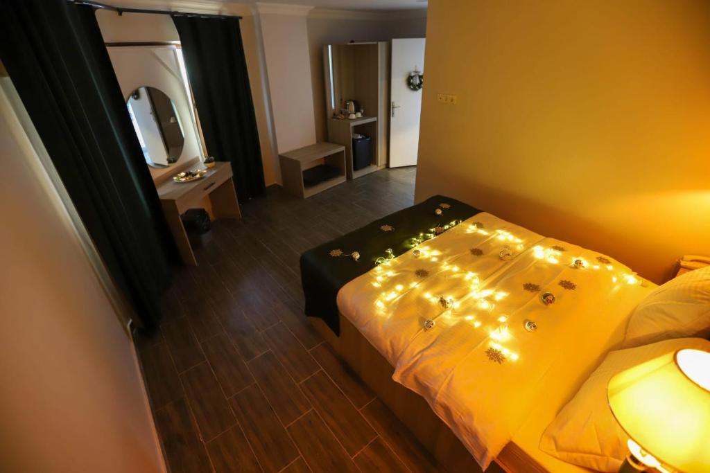 a bedroom with a bed with lights on it at NAYADA OTEL SPA in Sapanca