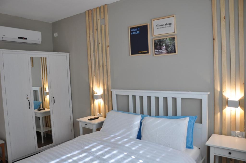 una camera con un letto bianco e due comodini di Engel apartments -גליל עליון a Tsiv'on