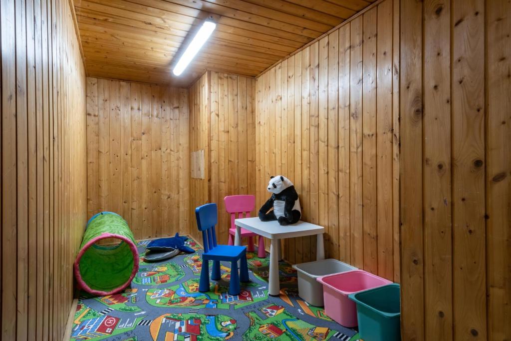 a room with a stuffed panda bear sitting on a table at Wellness Hotel Šedý Vlk in Harrachov