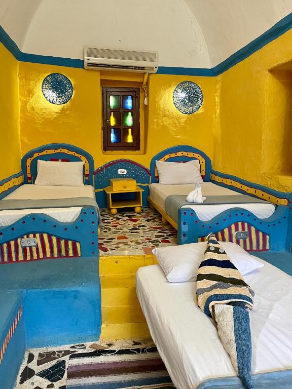 Postel nebo postele na pokoji v ubytování Nubian palace - by kerma hospitality
