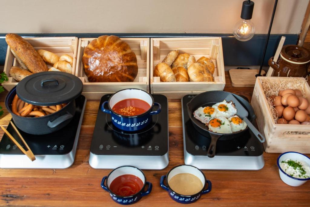 a table topped with different types of food on trays at Wellness Hotel Šedý Vlk in Harrachov