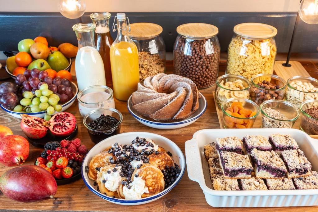 a table topped with lots of different types of breakfast foods at Wellness Hotel Šedý Vlk in Harrachov