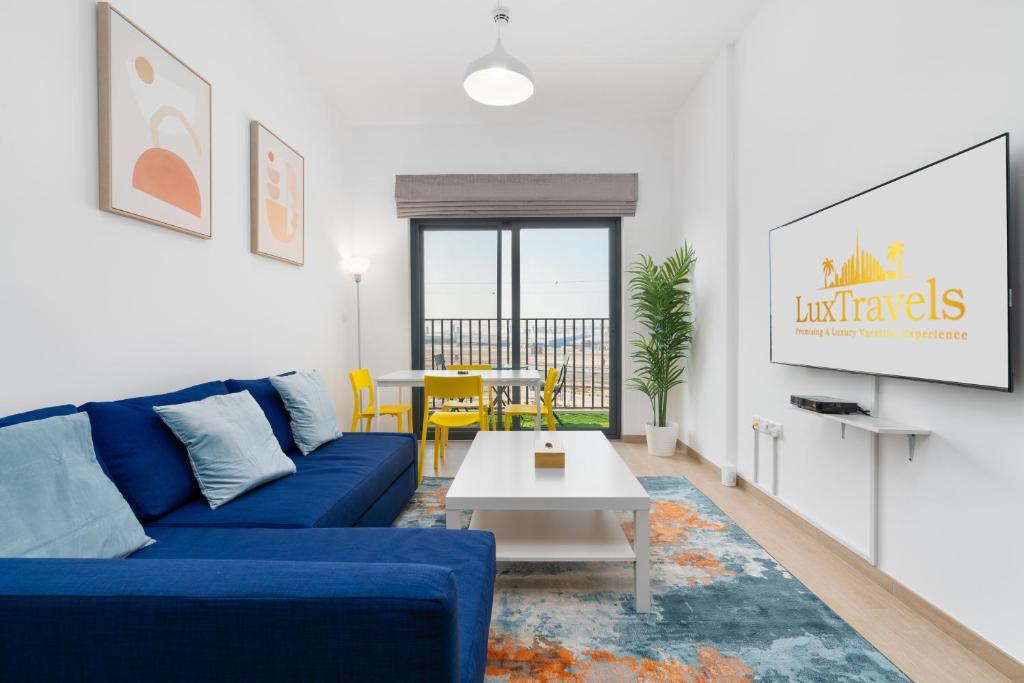 杜拜的住宿－Lux BnB Nook -2 I City Views，客厅配有蓝色的沙发和桌子