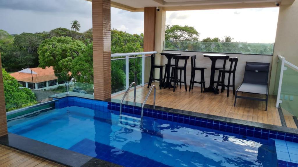 a house with a swimming pool and a balcony at Hotel Camocim in Camocim