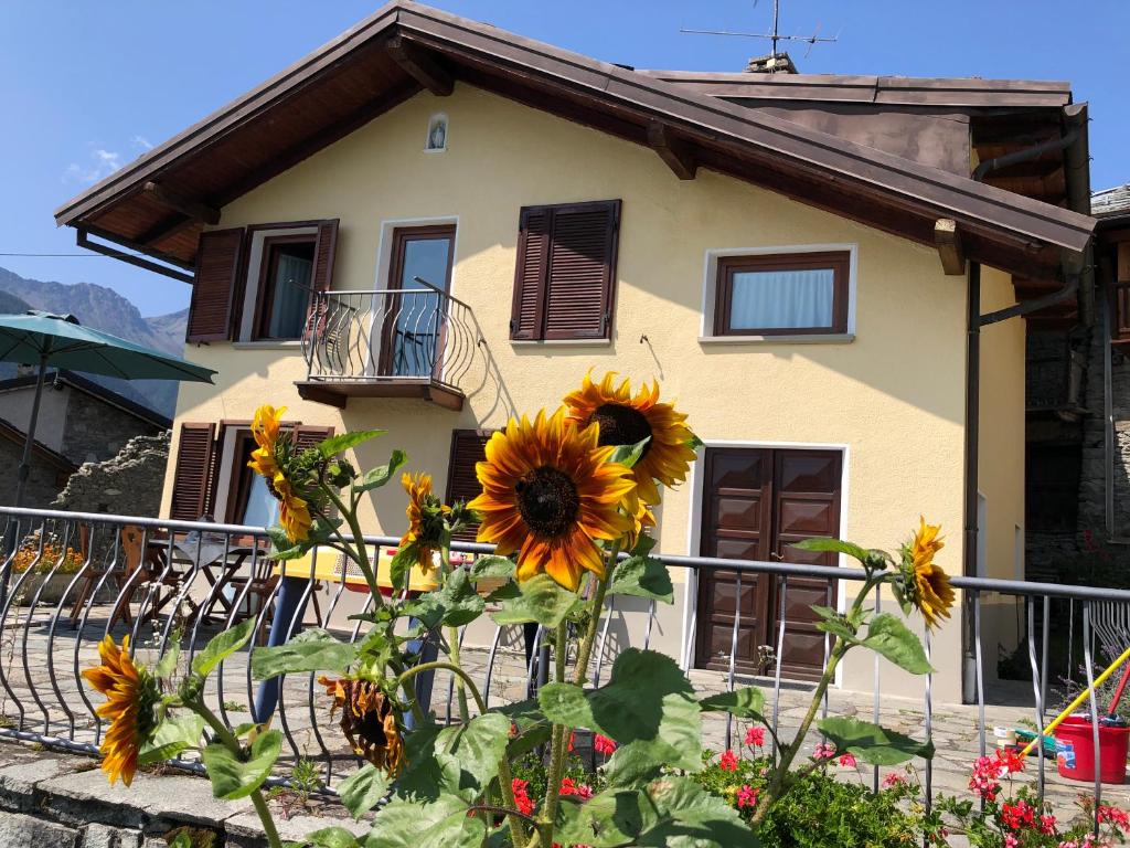 a house with a sunflower in front of it at La Ville CIR 00002 in Allein