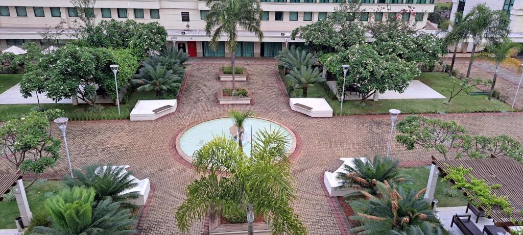 un patio con piscina y árboles y un edificio en Apart Hotel - Park Sul, en Brasilia