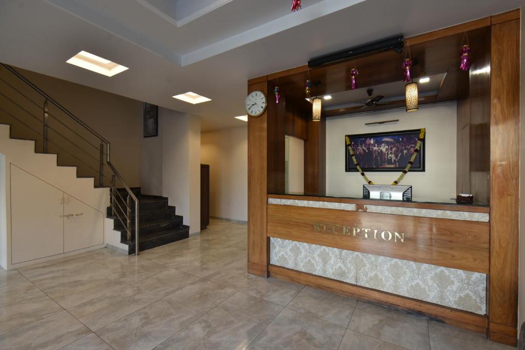 a lobby with a reception desk in a building at Hotel Sai Sparsh in Shirdi