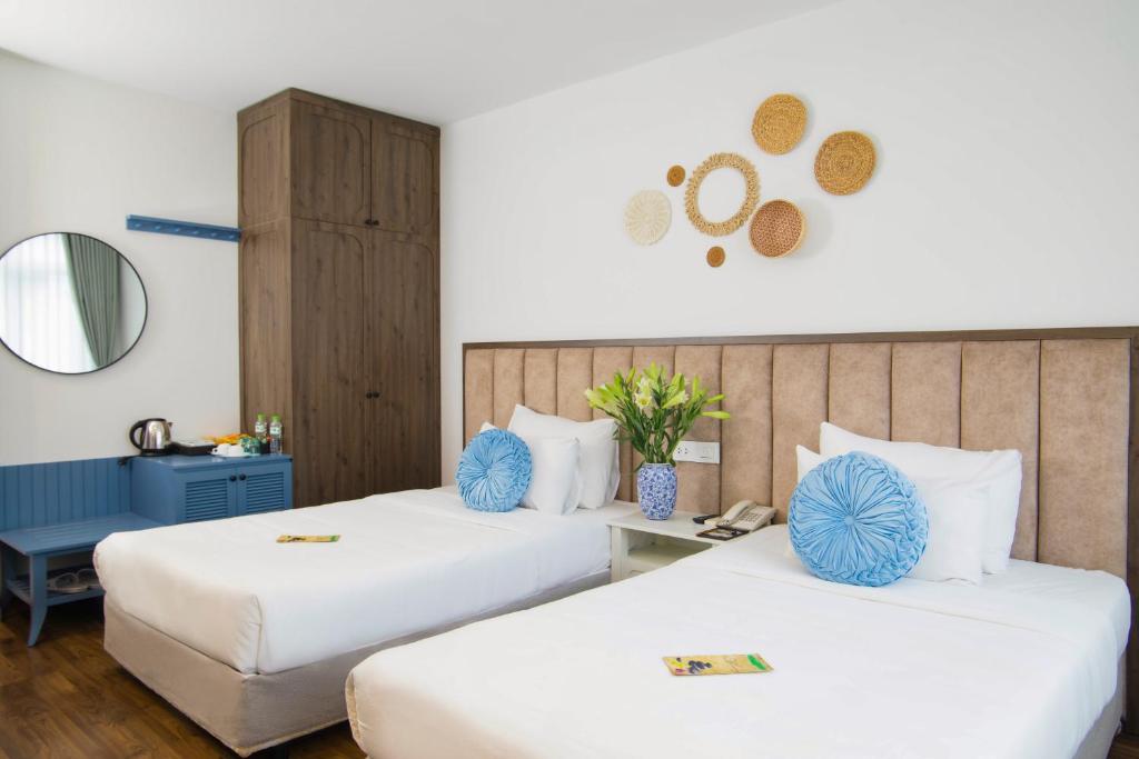 Postel nebo postele na pokoji v ubytování Western Hanoi Hotel